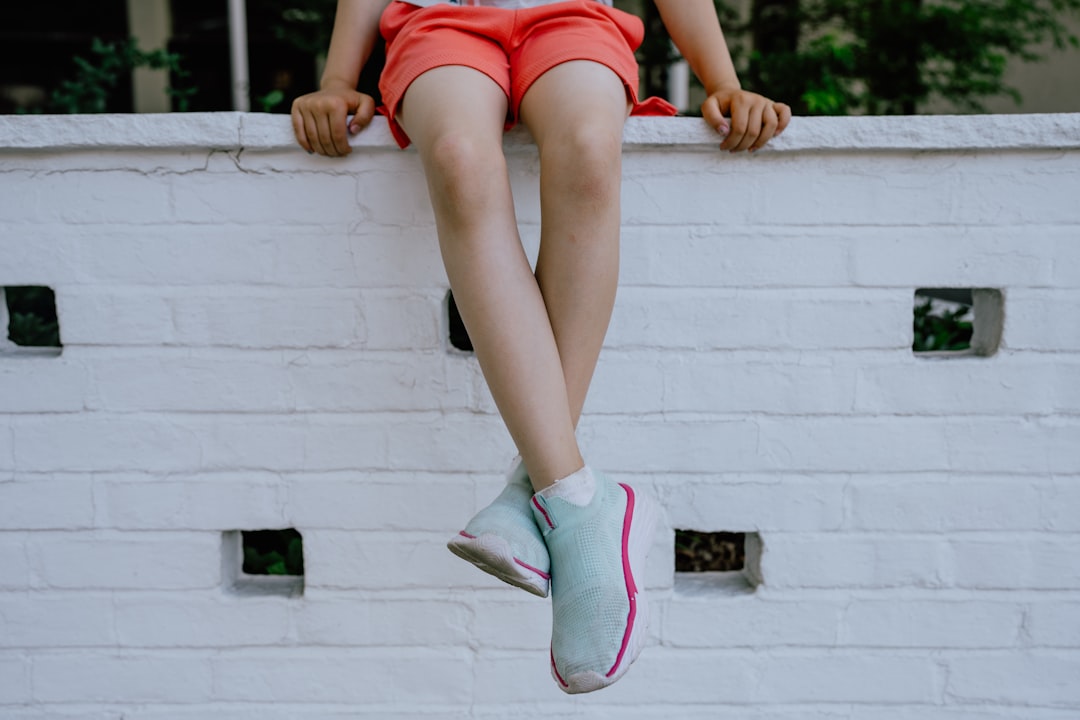 a woman leaning against a wall