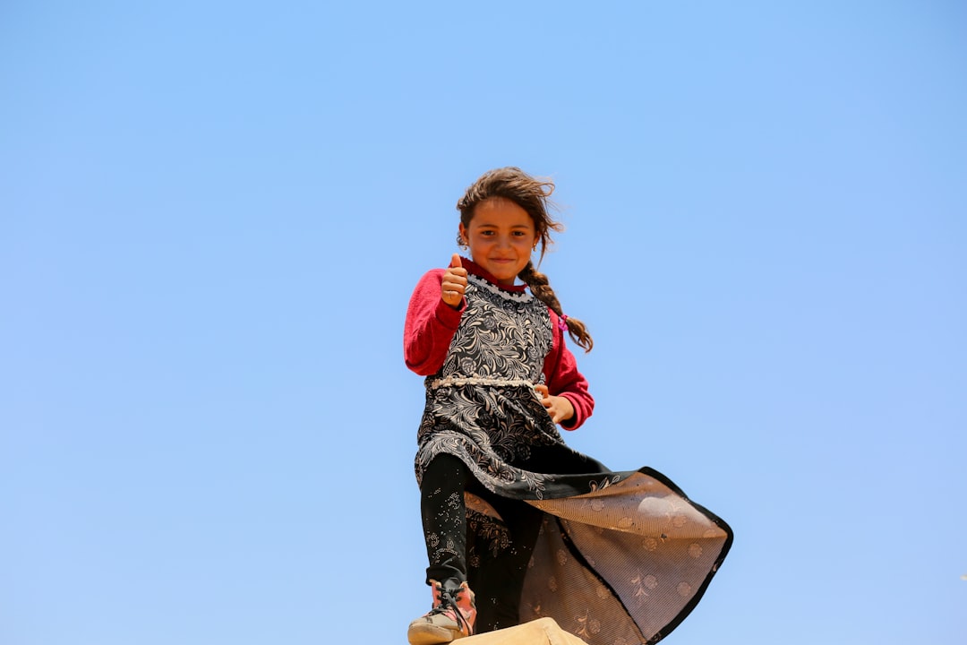 A little girl that is standing on a skateboard