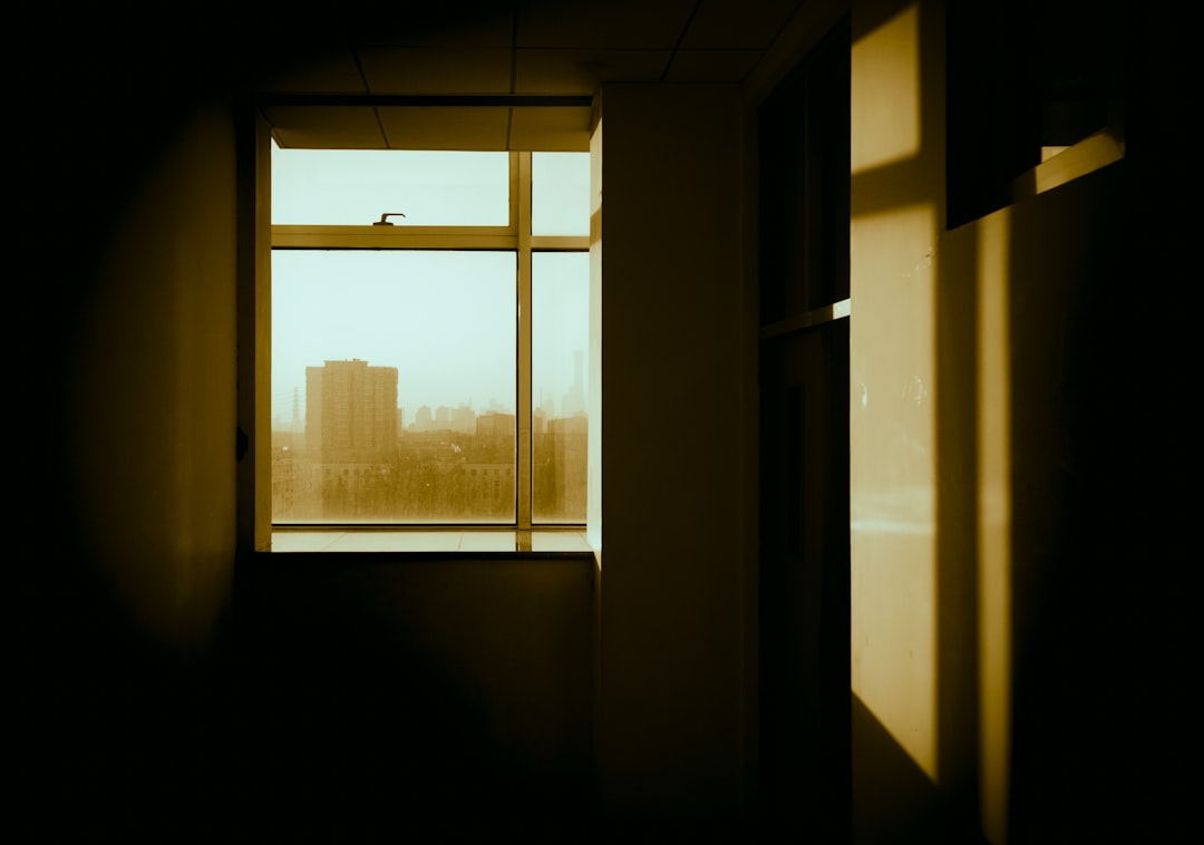 a room with a window and a view of a city