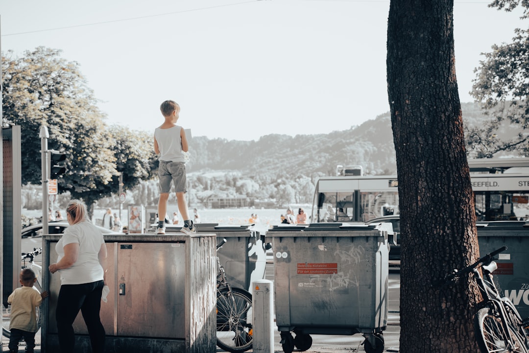 a man standing on top of a metal box next to a tree
